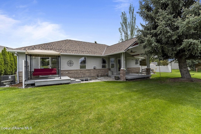 3025 N Sand Trap Way, Post Falls, ID 83854 - back of house with cooling unit, a shingled roof, brick siding, and a wooden deck