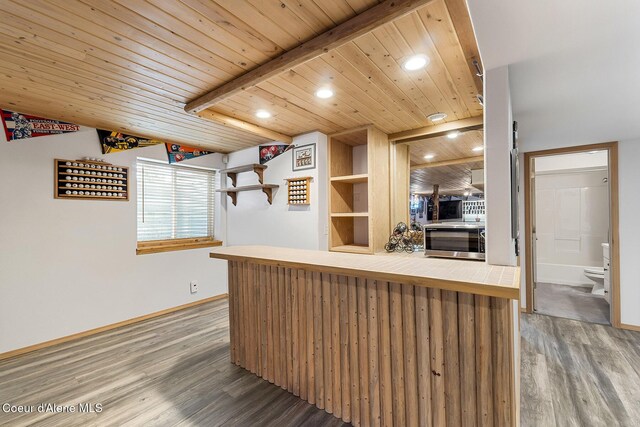 3025 N Sand Trap Way, Post Falls, ID 83854 - kitchen with wood finished floors, stainless steel microwave, recessed lighting, baseboards, and wood ceiling