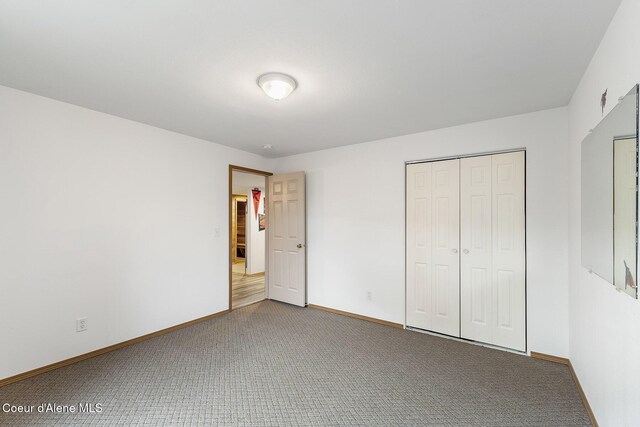 3025 N Sand Trap Way, Post Falls, ID 83854 - unfurnished bedroom featuring carpet, baseboards, and a closet