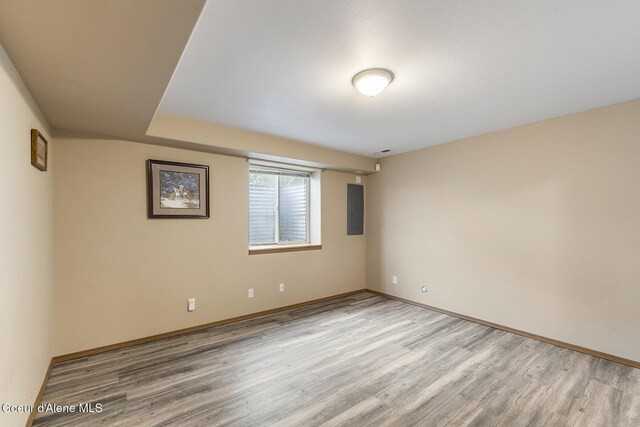 3025 N Sand Trap Way, Post Falls, ID 83854 - spare room with light wood finished floors, electric panel, and baseboards