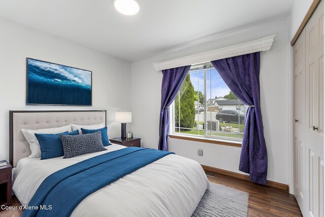 3025 N Sand Trap Way, Post Falls, ID 83854 - bedroom featuring wood finished floors, baseboards, and a closet