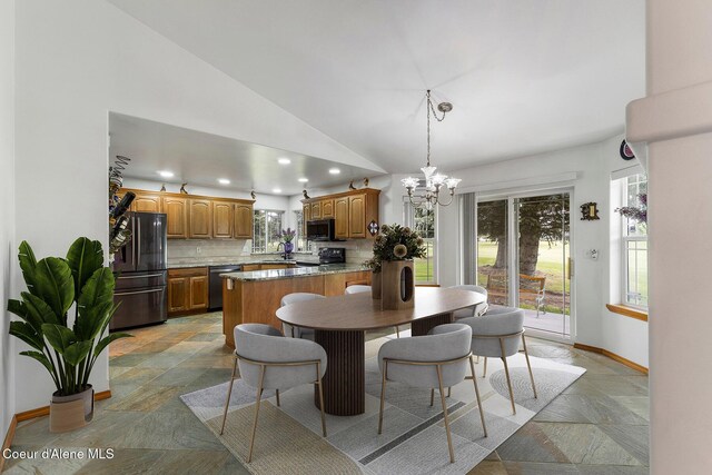 3025 N Sand Trap Way, Post Falls, ID 83854 - dining area with stone tile floors, vaulted ceiling, a chandelier, recessed lighting, and healthy amount of natural light