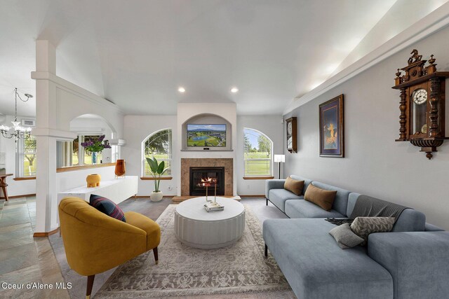 3025 N Sand Trap Way, Post Falls, ID 83854 - living room with recessed lighting, healthy amount of natural light, lofted ceiling, a glass covered fireplace, and baseboards