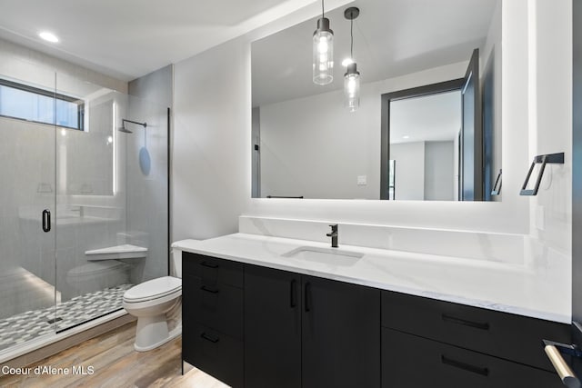 2888 W Lumber Ln, Coeur Dalene, ID 83814 - full bathroom featuring vanity, toilet, a shower stall, and wood finished floors