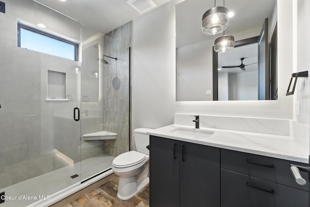 2888 W Lumber Ln, Coeur Dalene, ID 83814 - full bath with toilet, vanity, a shower stall, ceiling fan, and wood finished floors