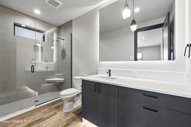 2888 W Lumber Ln, Coeur Dalene, ID 83814 - bathroom with toilet, wood finished floors, vanity, and a shower stall