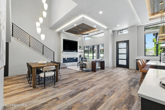 2888 W Lumber Ln, Coeur Dalene, ID 83814 - interior space with wood finished floors, a large fireplace, a high ceiling, recessed lighting, and baseboards