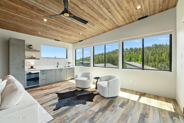 2888 W Lumber Ln, Coeur Dalene, ID 83814 - living area with beverage cooler, wood ceiling, a ceiling fan, recessed lighting, and wet bar