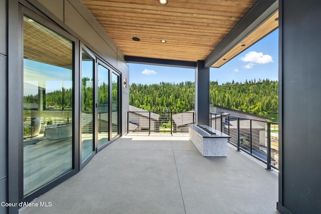 2888 W Lumber Ln, Coeur Dalene, ID 83814 - view of patio featuring a view of trees and a balcony