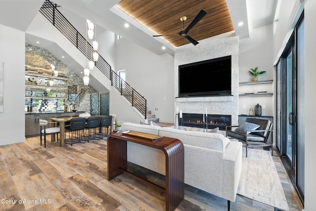 2888 W Lumber Ln, Coeur Dalene, ID 83814 - living area with a stone fireplace, recessed lighting, wood finished floors, wooden ceiling, and ceiling fan