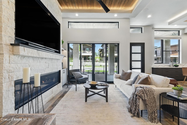2888 W Lumber Ln, Coeur Dalene, ID 83814 - living room with a glass covered fireplace, wood finished floors, recessed lighting, and a high ceiling