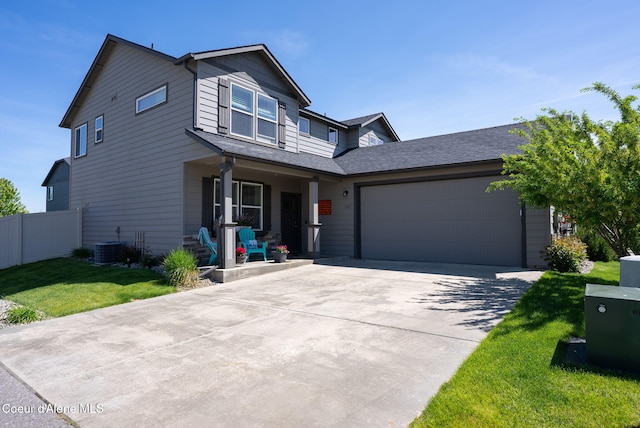 3423 E Hope Ave, Post Falls, ID 83854 - view of front facade with a porch, an attached garage, concrete driveway, central AC, and roof with shingles