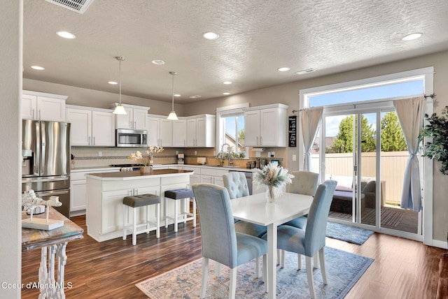 3423 E Hope Ave, Post Falls, ID 83854 - dining area featuring a textured ceiling, dark wood finished floors, and recessed lighting