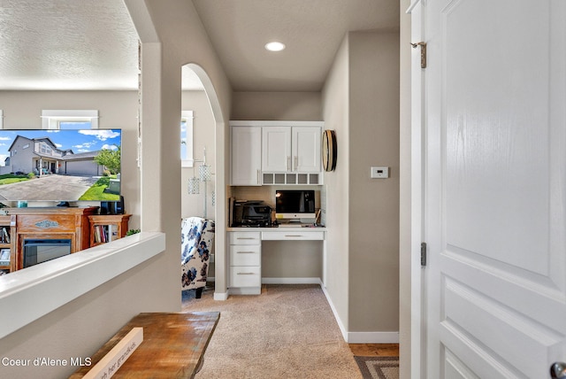 3423 E Hope Ave, Post Falls, ID 83854 - office featuring light colored carpet, arched walkways, baseboards, and recessed lighting