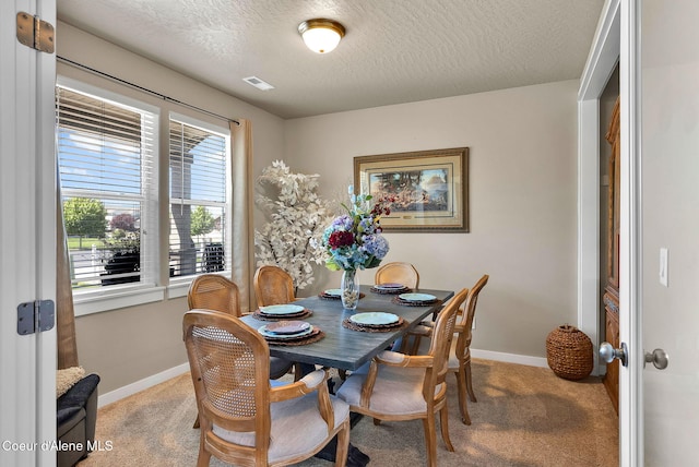 3423 E Hope Ave, Post Falls, ID 83854 - dining room with light colored carpet, baseboards, a textured ceiling, and french doors