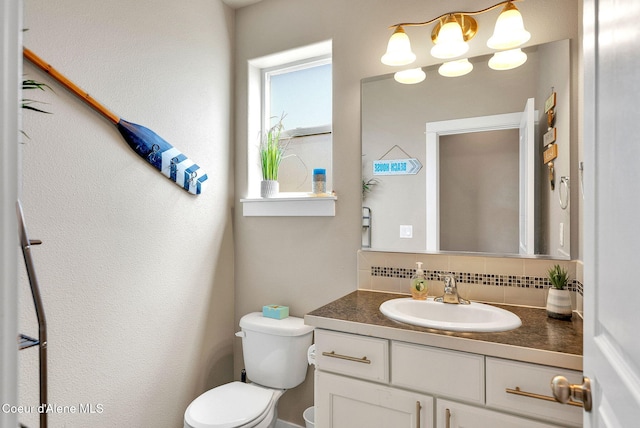3423 E Hope Ave, Post Falls, ID 83854 - half bath featuring tasteful backsplash, toilet, and vanity