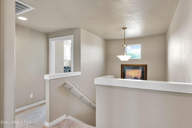 3423 E Hope Ave, Post Falls, ID 83854 - staircase featuring a fireplace, carpet floors, baseboards, and a textured ceiling