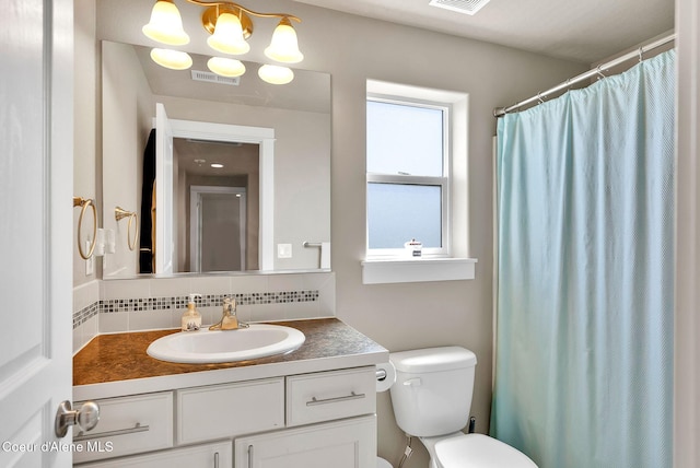3423 E Hope Ave, Post Falls, ID 83854 - full bath featuring backsplash, toilet, vanity, and a shower with shower curtain