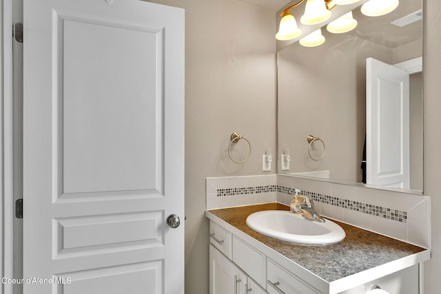 3423 E Hope Ave, Post Falls, ID 83854 - bathroom with decorative backsplash, vanity, and a chandelier