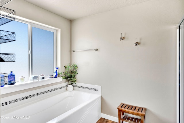 3423 E Hope Ave, Post Falls, ID 83854 - bathroom featuring a bath and wood finished floors