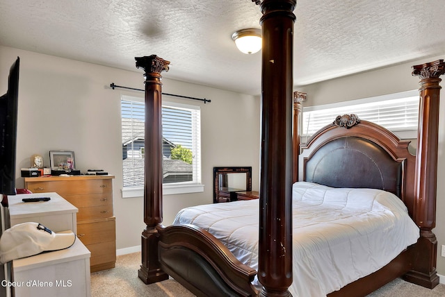 3423 E Hope Ave, Post Falls, ID 83854 - bedroom featuring light colored carpet, multiple windows, a textured ceiling, and baseboards