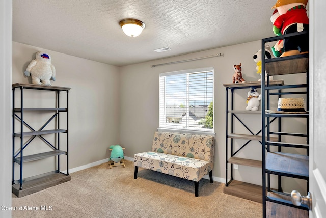 3423 E Hope Ave, Post Falls, ID 83854 - sitting room with carpet flooring, a textured ceiling, and baseboards