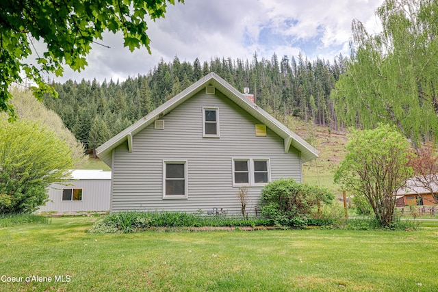 59A Creek Side Dr, Wallace, ID 83873 - view of side of home with a wooded view and a yard