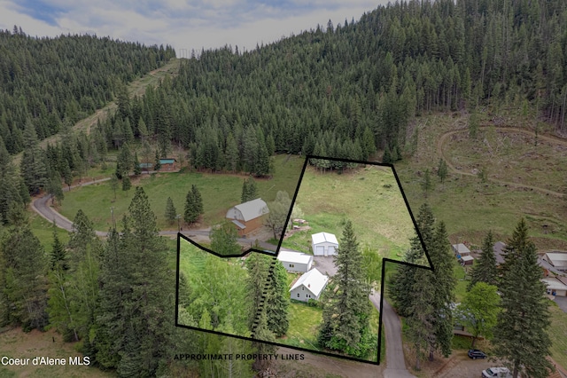 59A Creek Side Dr, Wallace, ID 83873 - aerial view of property and surrounding area with property boundaries highlighted and a heavily wooded area