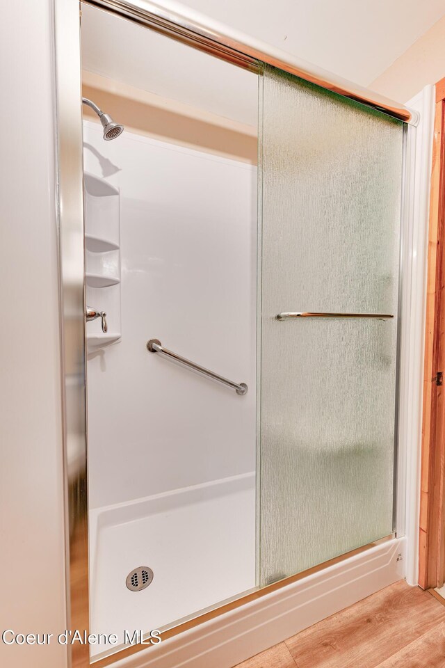 59A Creek Side Dr, Wallace, ID 83873 - full bathroom featuring a stall shower and wood finished floors