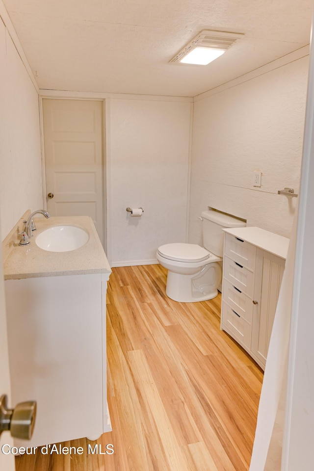 59A Creek Side Dr, Wallace, ID 83873 - half bathroom with vanity, toilet, and wood finished floors