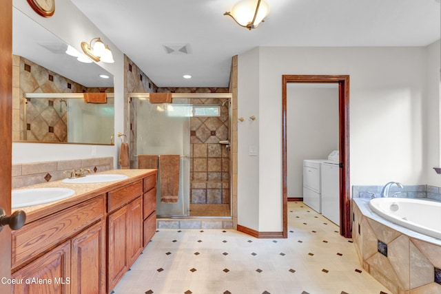 5340 W Hull Loop, Coeur Dalene, ID 83814 - bathroom with independent washer and dryer, a shower stall, a bath, double vanity, and tile patterned floors