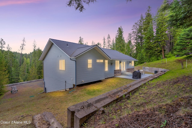 5340 W Hull Loop, Coeur Dalene, ID 83814 - back of house with a patio area and a yard