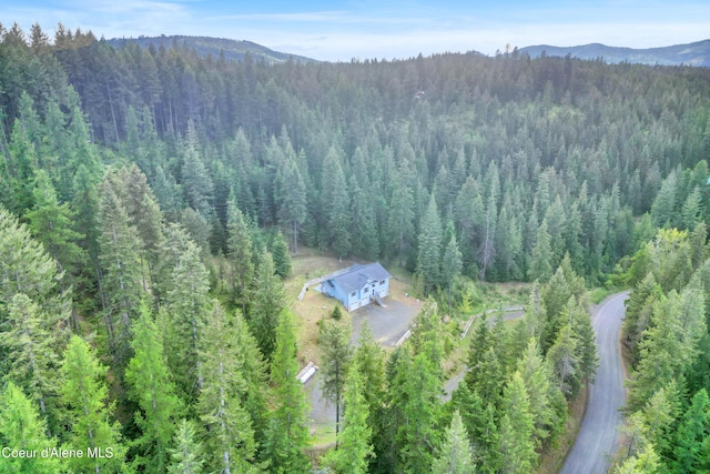 5340 W Hull Loop, Coeur Dalene, ID 83814 - aerial view of property and surrounding area featuring a forest and mountains