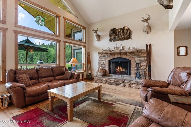 88 Fenway Dr, Sagle, ID 83860 - living room featuring wood finished floors, high vaulted ceiling, and a stone fireplace