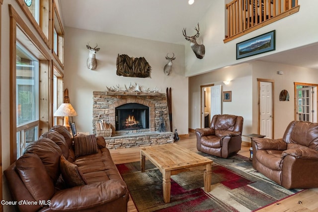 88 Fenway Dr, Sagle, ID 83860 - living area with wood finished floors, a towering ceiling, and a stone fireplace