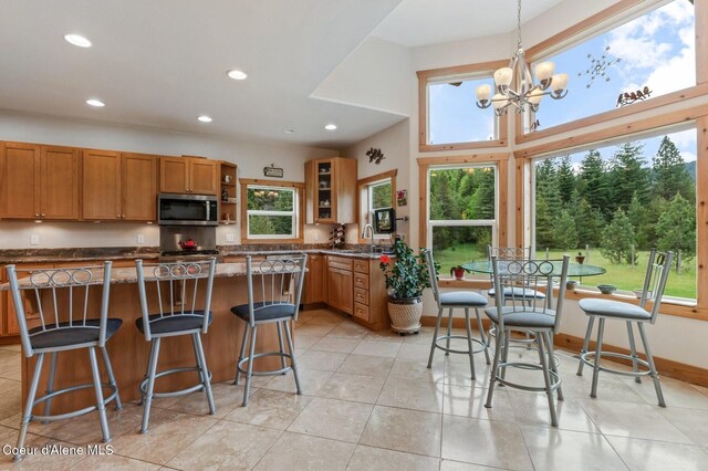 88 Fenway Dr, Sagle, ID 83860 - kitchen with stainless steel microwave, recessed lighting, a sink, a chandelier, and brown cabinets