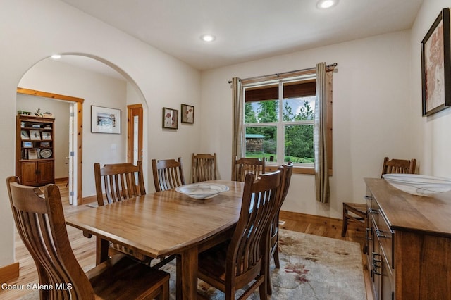 88 Fenway Dr, Sagle, ID 83860 - dining area featuring arched walkways, light wood finished floors, recessed lighting, and baseboards