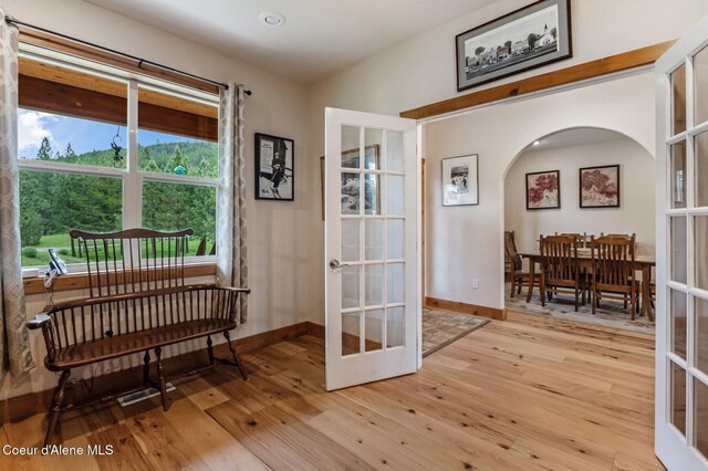 88 Fenway Dr, Sagle, ID 83860 - doorway featuring french doors, arched walkways, light wood-style floors, and baseboards