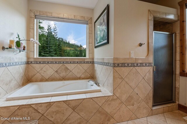 88 Fenway Dr, Sagle, ID 83860 - bathroom featuring a bath, a stall shower, tile patterned flooring, and wainscoting