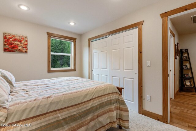 88 Fenway Dr, Sagle, ID 83860 - bedroom featuring a closet, baseboards, recessed lighting, and wood finished floors