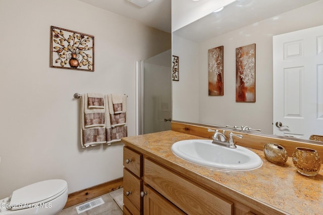 88 Fenway Dr, Sagle, ID 83860 - bathroom featuring vanity, a shower with door, toilet, tile patterned floors, and baseboards