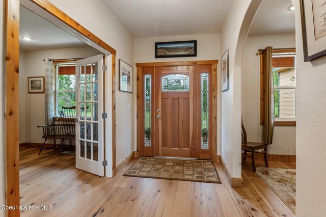 88 Fenway Dr, Sagle, ID 83860 - foyer entrance featuring arched walkways, light wood-type flooring, healthy amount of natural light, and baseboards