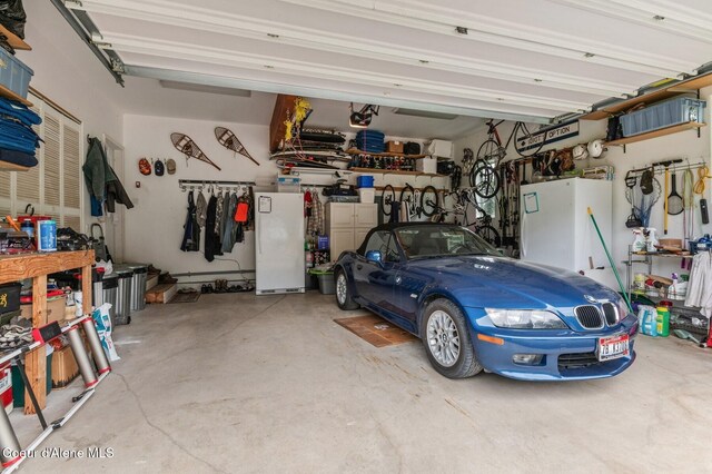 88 Fenway Dr, Sagle, ID 83860 - garage featuring a garage door opener and freestanding refrigerator