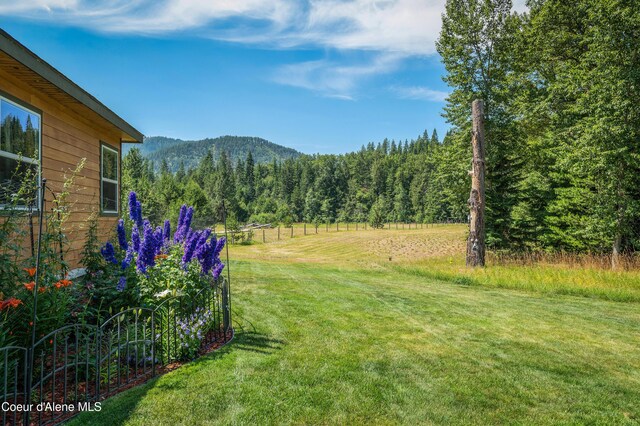 88 Fenway Dr, Sagle, ID 83860 - view of grassy yard featuring a view of trees and a mountain view