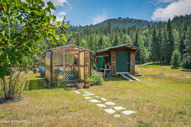 88 Fenway Dr, Sagle, ID 83860 - view of greenhouse with a view of trees and a yard