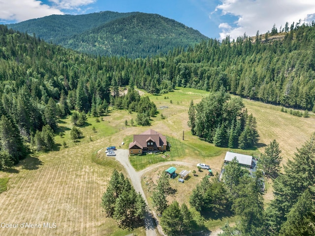 88 Fenway Dr, Sagle, ID 83860 - aerial view of property and surrounding area with a mountainous background, a heavily wooded area, and rural landscape