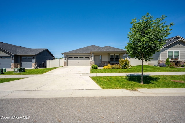 4717 N Connery Loop, Post Falls, ID 83854 - view of front of house with a garage, concrete driveway, and stone siding