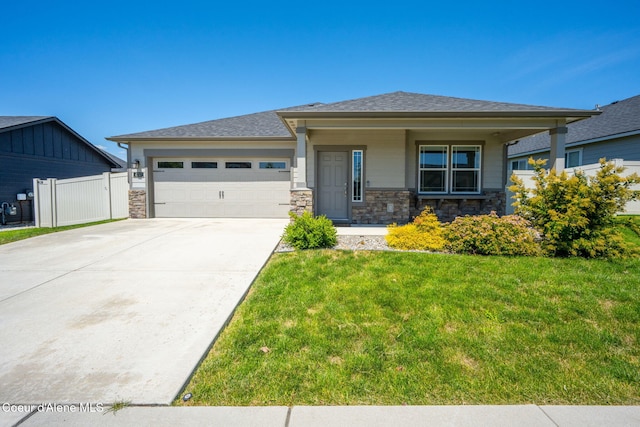 4717 N Connery Loop, Post Falls, ID 83854 - prairie-style house featuring an attached garage, stone siding, driveway, and a shingled roof