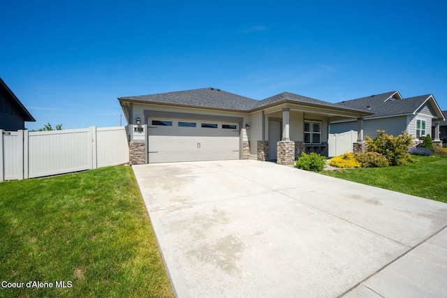 4717 N Connery Loop, Post Falls, ID 83854 - prairie-style house with an attached garage, concrete driveway, stone siding, and a gate