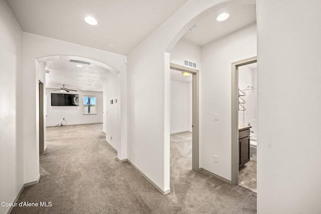 4717 N Connery Loop, Post Falls, ID 83854 - hall featuring arched walkways, carpet flooring, and recessed lighting